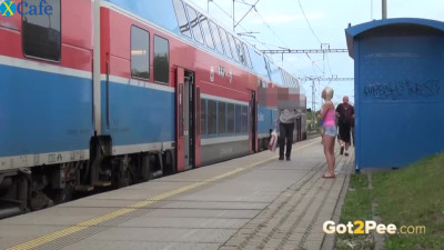 Pretty blonde gal takes her jean shirts off and pisses on the station