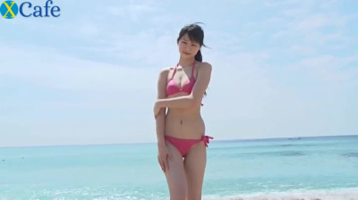 Slim Asian girl Tsukasa Arai walks on a sandy beach under the sun