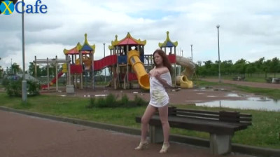 Redhead cute babe Lera exposes her tiny pink pussy on the playground