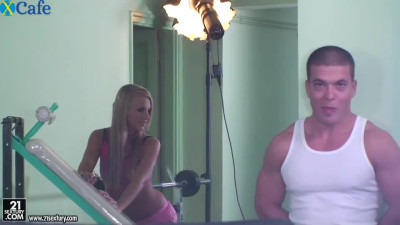 Seductive blond chick lifts up weights with her legs in front of horny coach