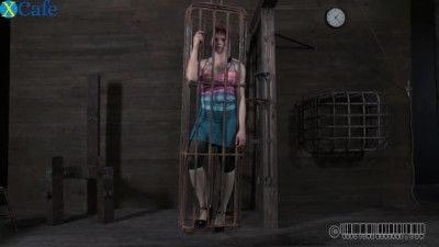 Wide boned red-haired hussy gets closed in the metal cage