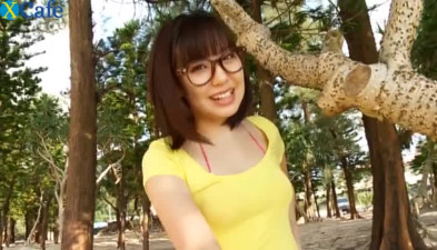 Cheesecake Japanese cutie twirls on the sand wearing tempting bikini