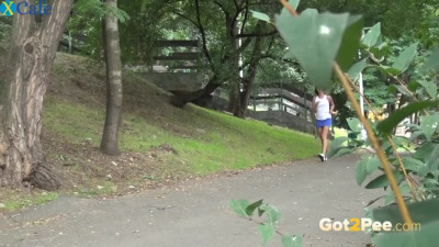 Charming chick with great rack pisses in the middle of her jogging