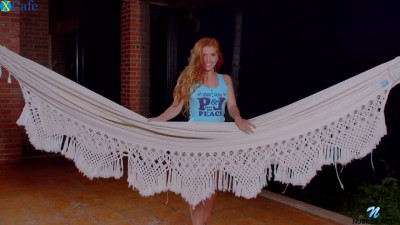 Sweet bright redhead Angelina Praga fingers her wet pussy in the hammock