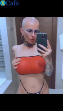 Bald chick fingering herself at the bathroom