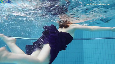 Redhead pale skin sexy babe in blue dress strips underwater in the pool