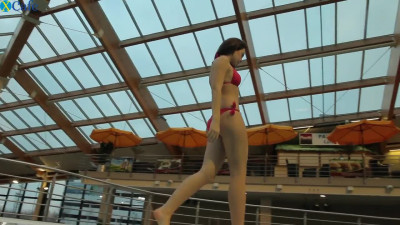 Adorable and fresh white babe in red bikini dives in the pool