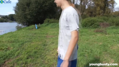 Redhead teen fucks passionately on a lawn outdoor