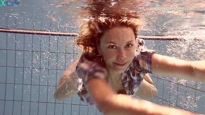 Ginger head hottie swimming naked in the pool