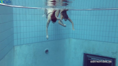 Two sexy teens swimming in the pool like sexy mermaids