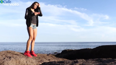 Beautiful girlie Sapphira taking selfies on a beach