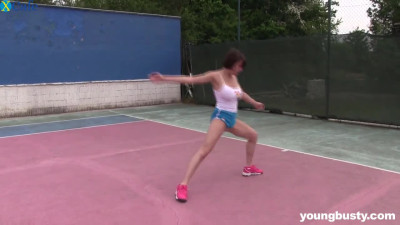 Sporty and fit girl with beautiful titties masturbating on a tennis court