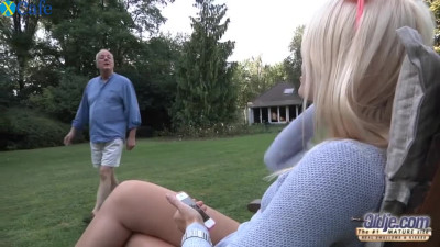 Stunning blonde  girl pleases old fart on the green grass